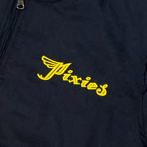 A close up of a black bomber jacket  with a yellow text logo reading "Pixies" on the chest. There is a yellow tag on the sleeve with black text reading "Remove Before Ignition."