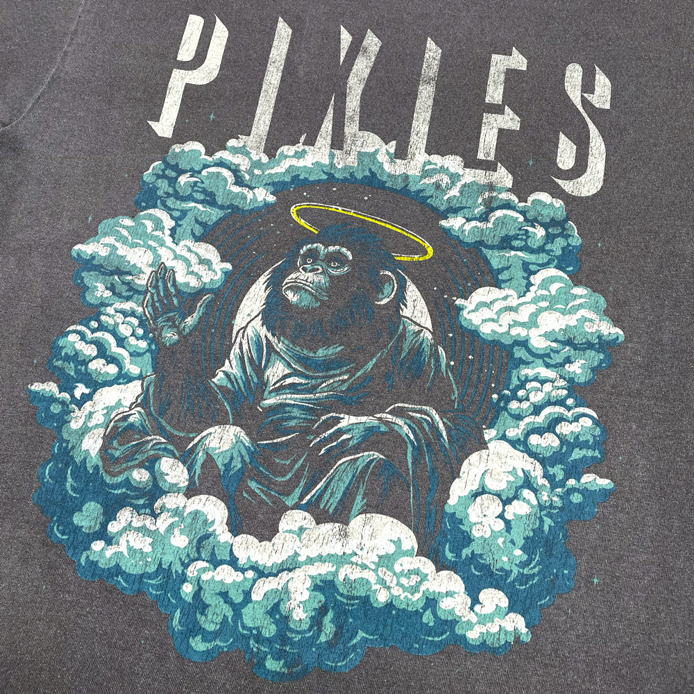 Faded Black T-Shirt against a white background with distressed light gray text reading "Pixies" and a design of an angelic monkey sitting amongst clouds.