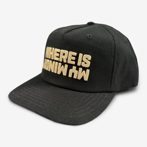 Three-quarter view of the black Pixies snapback showing tan “Where Is My Mind?” embroidery and the stitched brim.